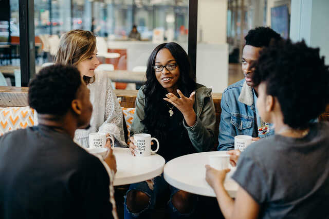 young adults having a discussion in a coffee shop