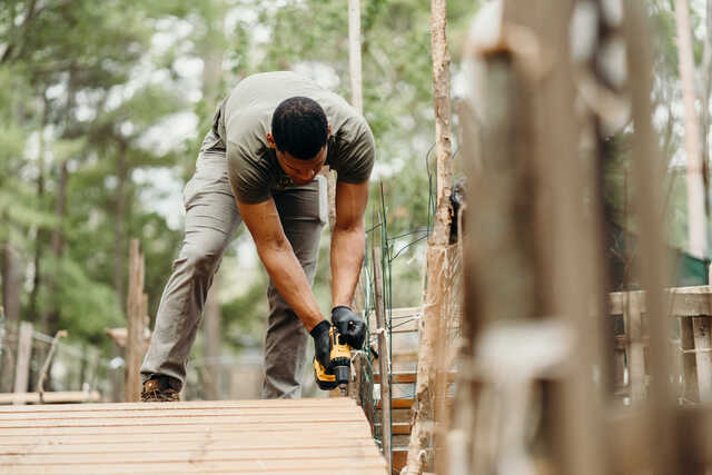 man helping build a walkway